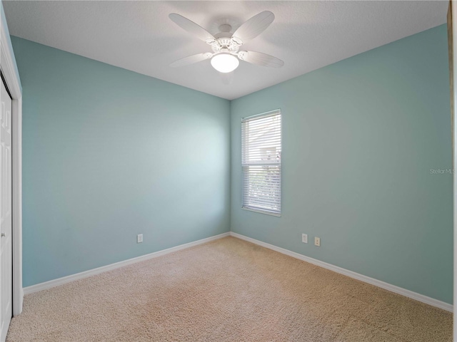 11982 Granite Woods Loop, Venice, FL 34292 - spare room featuring carpet, baseboards, and a ceiling fan