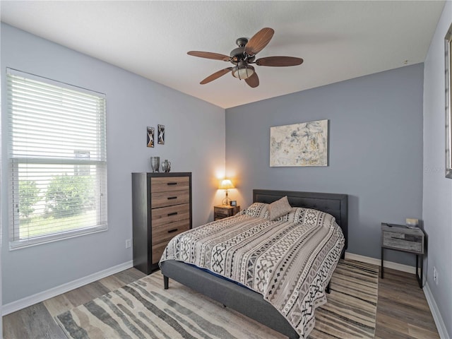 11982 Granite Woods Loop, Venice, FL 34292 - bedroom with wood finished floors, baseboards, and a ceiling fan