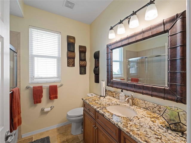 11982 Granite Woods Loop, Venice, FL 34292 - full bathroom featuring toilet, vanity, a shower stall, and baseboards