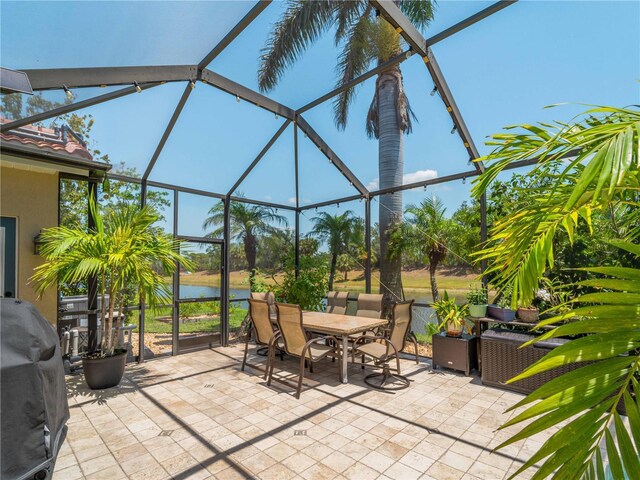 11982 Granite Woods Loop, Venice, FL 34292 - view of patio / terrace featuring glass enclosure, outdoor dining space, a water view, and a grill