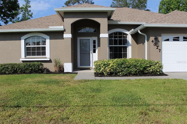 4027 Quaker Ln, North Port, FL 34288 - property entrance with stucco siding, a shingled roof, and a yard