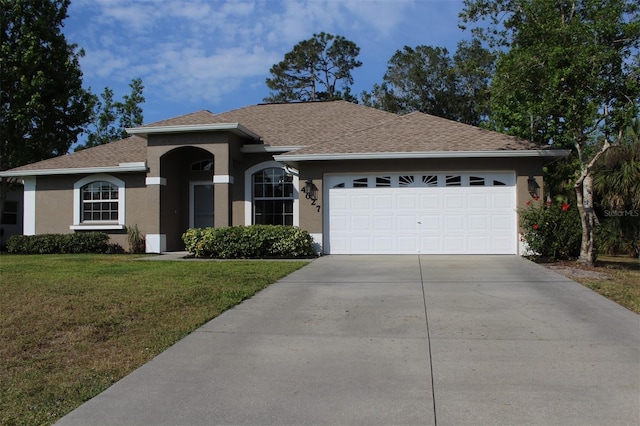 4027 Quaker Ln, North Port, FL 34288 - ranch-style house with stucco siding, driveway, a front lawn, a garage, and a shingled roof