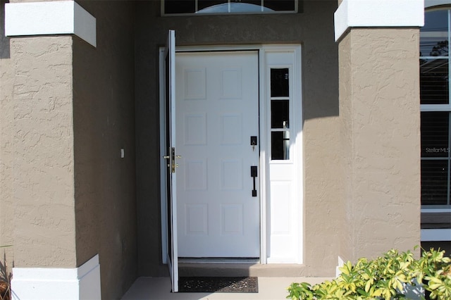 4027 Quaker Ln, North Port, FL 34288 - doorway to property featuring stucco siding