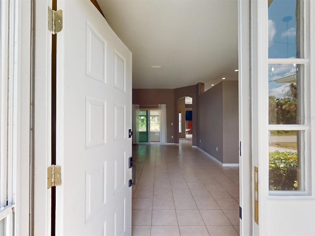 4027 Quaker Ln, North Port, FL 34288 - entryway with arched walkways, light tile patterned floors, and baseboards