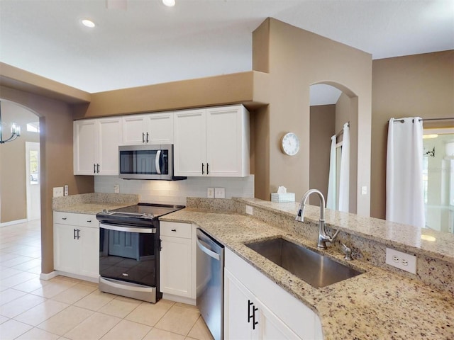 4027 Quaker Ln, North Port, FL 34288 - kitchen featuring stainless steel appliances, a sink, light tile patterned floors, white cabinets, and recessed lighting