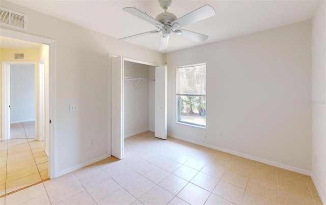 4027 Quaker Ln, North Port, FL 34288 - unfurnished bedroom featuring light tile patterned floors, a closet, ceiling fan, and baseboards