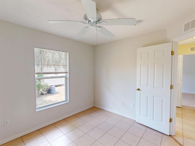 4027 Quaker Ln, North Port, FL 34288 - spare room with light tile patterned flooring, a ceiling fan, and baseboards