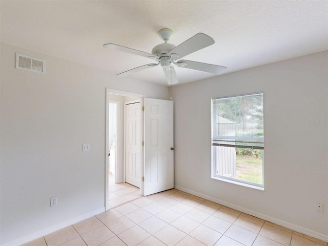 4027 Quaker Ln, North Port, FL 34288 - empty room with ceiling fan, baseboards, and light tile patterned flooring