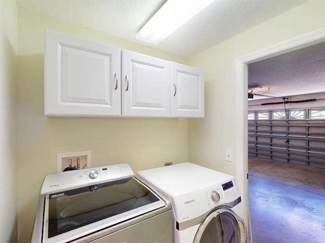 4027 Quaker Ln, North Port, FL 34288 - clothes washing area with cabinet space, washing machine and dryer, and a textured ceiling
