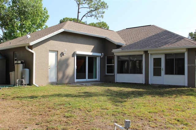 4027 Quaker Ln, North Port, FL 34288 - rear view of property featuring stucco siding, a yard, roof with shingles, and a sunroom