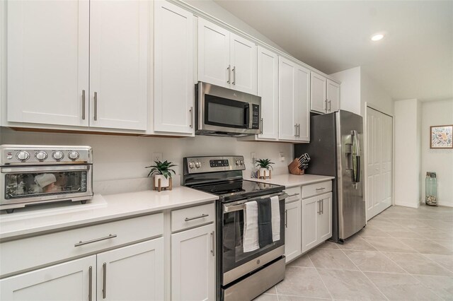 43984 Boardwalk Loop Unit 1726, Punta Gorda, FL 33982 - kitchen featuring appliances with stainless steel finishes, light countertops, white cabinetry, light tile patterned floors, and recessed lighting