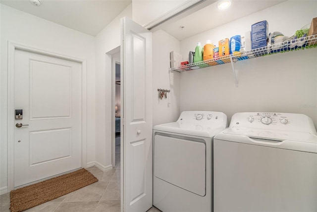 43984 Boardwalk Loop Unit 1726, Punta Gorda, FL 33982 - clothes washing area featuring washing machine and dryer, light tile patterned flooring, and baseboards