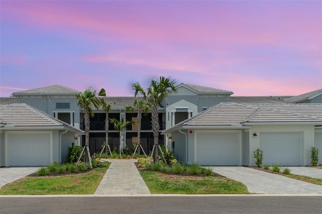 43984 Boardwalk Loop Unit 1726, Punta Gorda, FL 33982 - view of front of house with a tile roof, stucco siding, and a garage