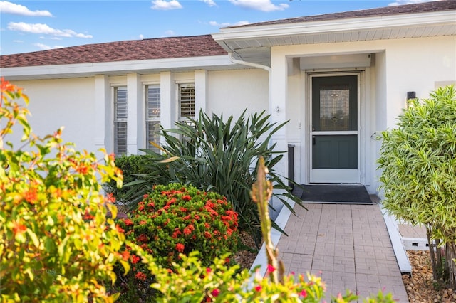 3301 Santa Barbara Dr, Punta Gorda, FL 33983 - property entrance with stucco siding and a shingled roof