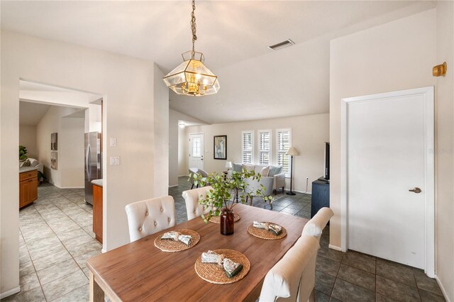 3301 Santa Barbara Dr, Punta Gorda, FL 33983 - dining area with vaulted ceiling, light tile patterned flooring, and baseboards