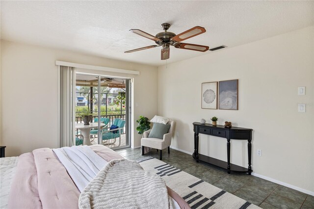 3301 Santa Barbara Dr, Punta Gorda, FL 33983 - bedroom featuring access to exterior, a textured ceiling, baseboards, a ceiling fan, and tile patterned flooring