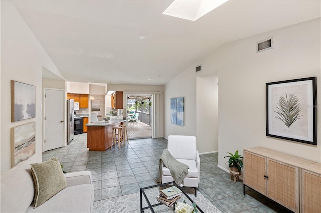 3301 Santa Barbara Dr, Punta Gorda, FL 33983 - living room with vaulted ceiling, a skylight, and baseboards