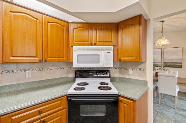 3301 Santa Barbara Dr, Punta Gorda, FL 33983 - kitchen with white microwave, electric range, and brown cabinetry