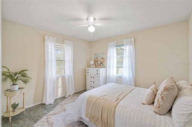 3301 Santa Barbara Dr, Punta Gorda, FL 33983 - bedroom with multiple windows, ceiling fan, and baseboards