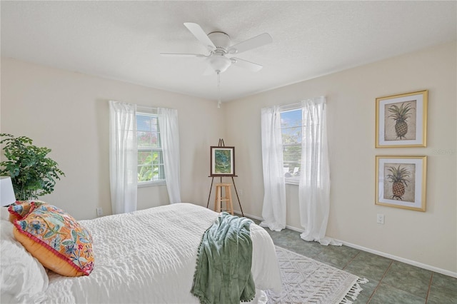 3301 Santa Barbara Dr, Punta Gorda, FL 33983 - bedroom with multiple windows, baseboards, and a ceiling fan