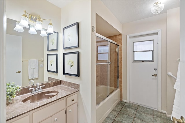 3301 Santa Barbara Dr, Punta Gorda, FL 33983 - full bathroom with baseboards, vanity, enclosed tub / shower combo, tile patterned floors, and a textured ceiling