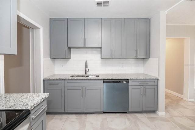 kitchen with dishwasher, a sink, gray cabinets, tasteful backsplash, and light stone countertops