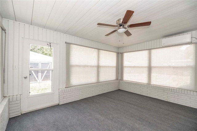unfurnished sunroom featuring ceiling fan and an AC wall unit