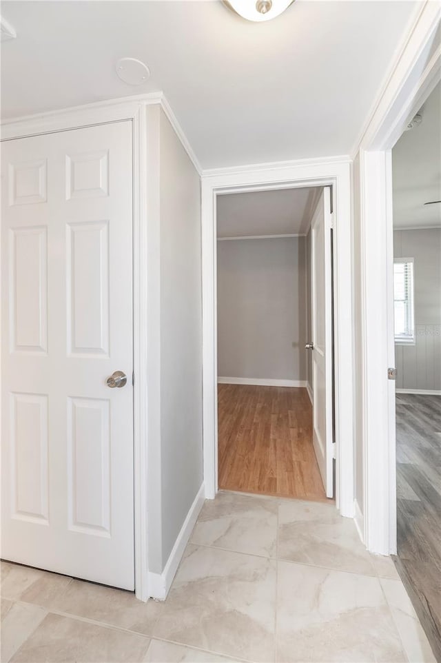 hallway featuring baseboards and light wood-style floors