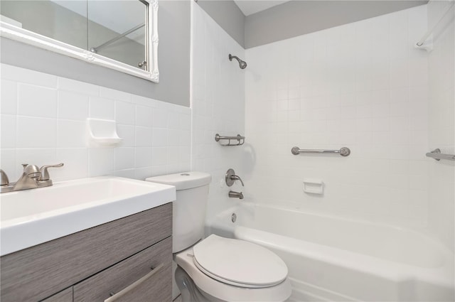 full bath with bathing tub / shower combination, toilet, tile walls, and vanity