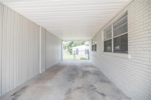 view of patio featuring an attached carport and fence