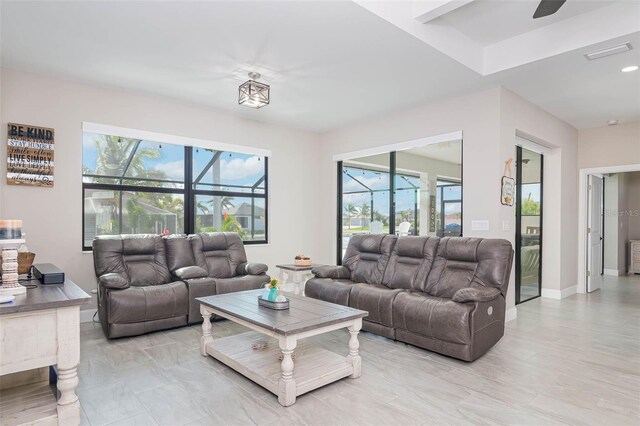 living room featuring a ceiling fan, recessed lighting, and baseboards
