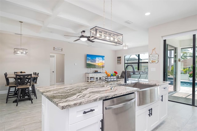 kitchen with stainless steel dishwasher, coffered ceiling, an island with sink, a sink, and light stone countertops