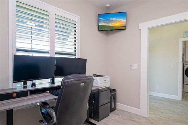 office area with baseboards and washer / clothes dryer