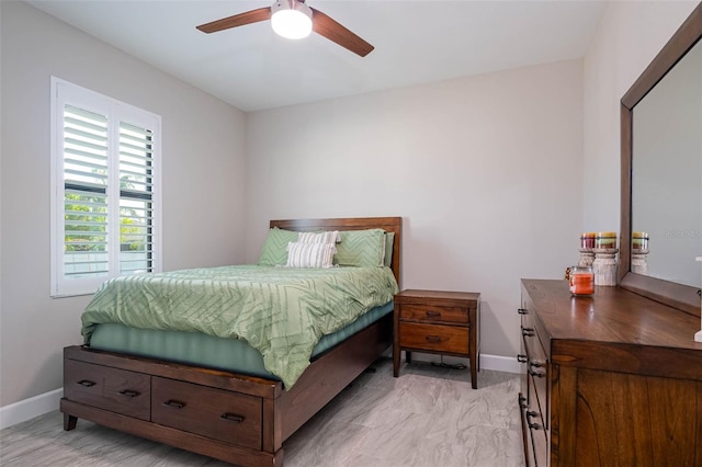 bedroom with baseboards and a ceiling fan