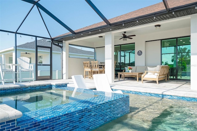 swimming pool with a ceiling fan, an outdoor hot tub, a patio, glass enclosure, and an outdoor hangout area