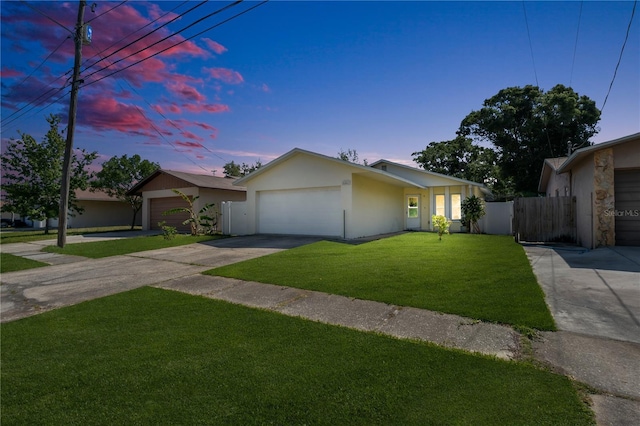 view of front facade featuring driveway, stucco siding, and an attached garage