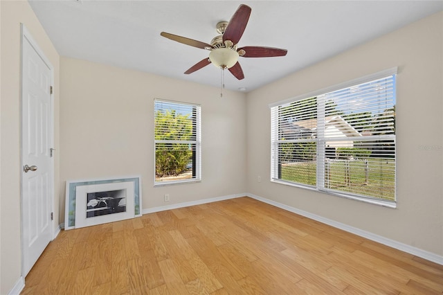 27038 San Jorge Dr, Punta Gorda, FL 33983 - unfurnished living room with light wood-style flooring, baseboards, and a ceiling fan