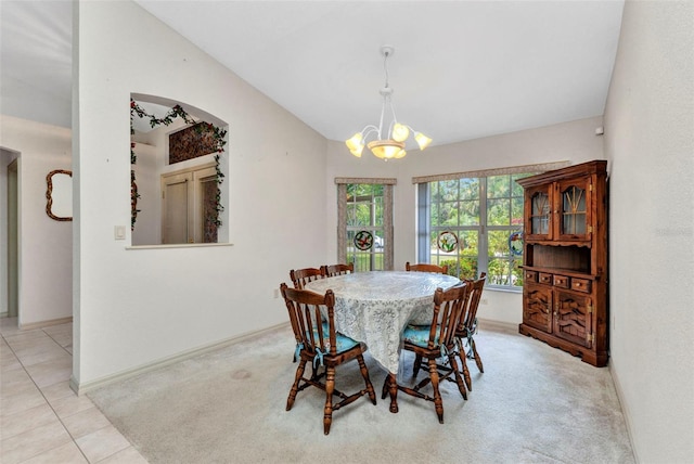 dining area featuring a chandelier, vaulted ceiling, baseboards, carpet flooring, and tile patterned flooring