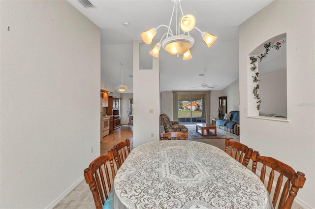 dining room featuring baseboards, vaulted ceiling, carpet floors, ceiling fan, and a chandelier
