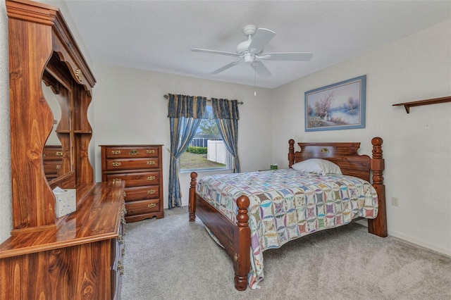 carpeted bedroom with a ceiling fan and baseboards