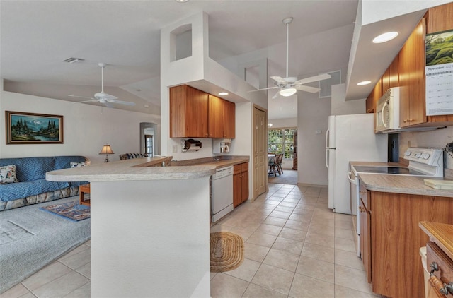 kitchen with ceiling fan, white appliances, open floor plan, lofted ceiling, and light tile patterned floors