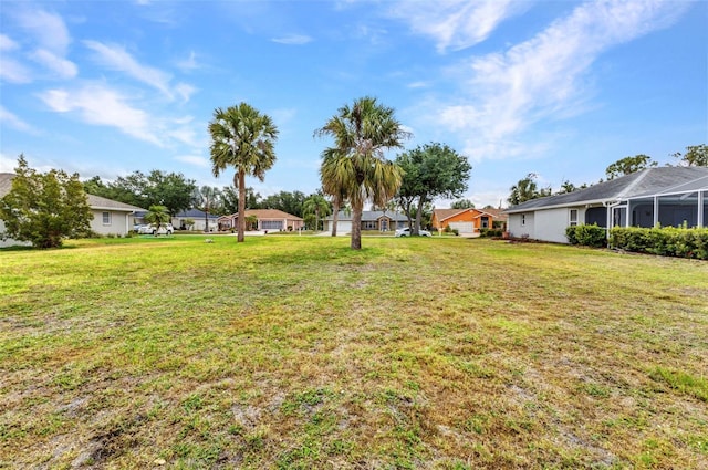 view of green lawn with a residential view