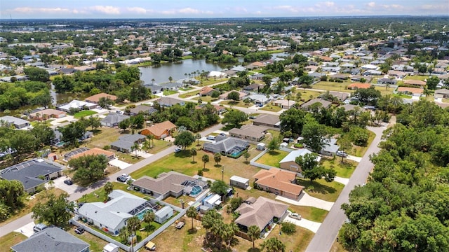 aerial view of property and surrounding area with nearby suburban area and a nearby body of water