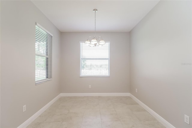 20067 Oakflower Ave, Tampa, FL 33647 - unfurnished room with a chandelier and baseboards