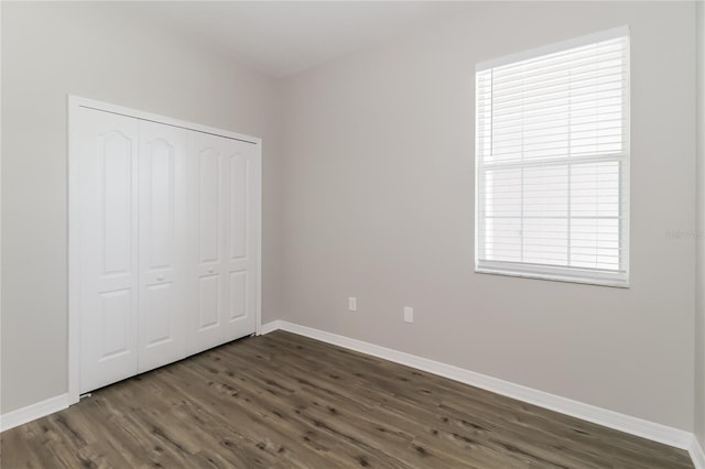 20067 Oakflower Ave, Tampa, FL 33647 - unfurnished bedroom with dark wood-type flooring, baseboards, and a closet