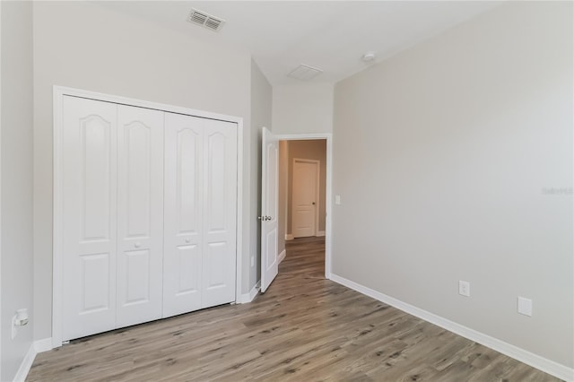 20067 Oakflower Ave, Tampa, FL 33647 - unfurnished bedroom with light wood-style flooring, a closet, and baseboards