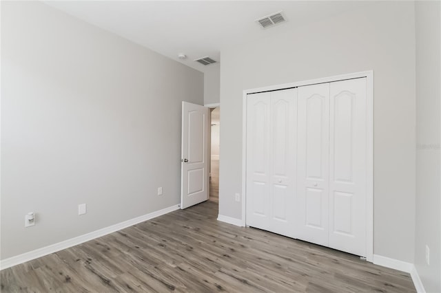20067 Oakflower Ave, Tampa, FL 33647 - unfurnished bedroom with wood finished floors, baseboards, and a closet