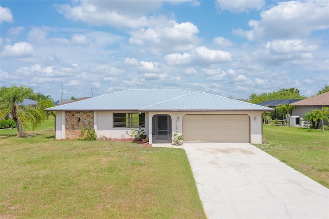 27050 Pelotas Dr, Punta Gorda, FL 33983 - ranch-style home featuring an attached garage, a front yard, driveway, stucco siding, and metal roof