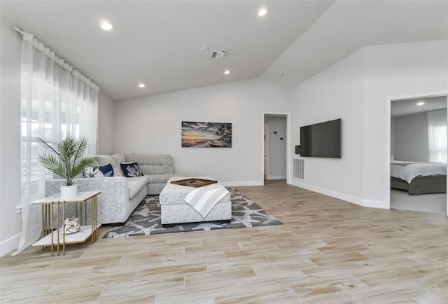 7664 Meroni Blvd, North Port, FL 34291 - living room with recessed lighting, baseboards, lofted ceiling, and light wood finished floors