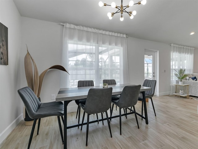 7664 Meroni Blvd, North Port, FL 34291 - dining space featuring a chandelier, baseboards, and light wood-style floors